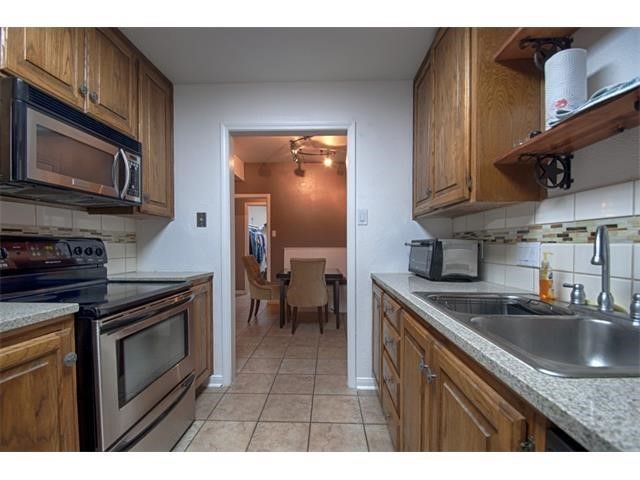 2529 Rio Grande Street, Unit 69 Austin, TX 78705 - Photo 2 of 25 a kitchen with stainless steel appliances granite countertop a sink stove and microwave