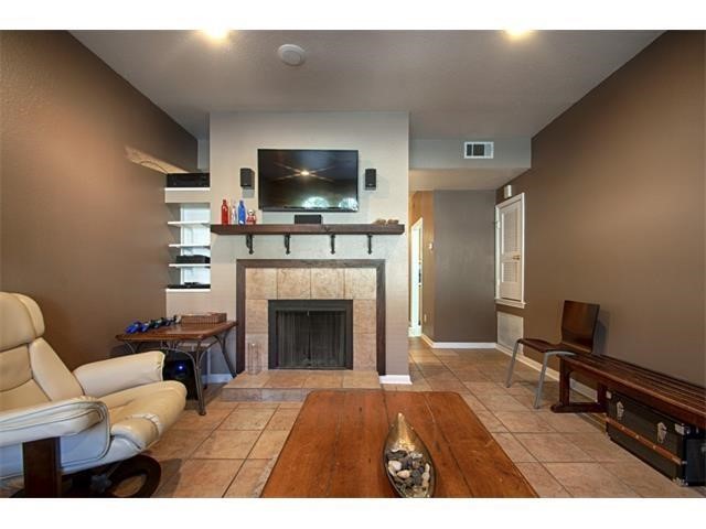 2529 Rio Grande Street, Unit 69 Austin, TX 78705 - Photo 8 of 25 a living room with furniture a flat screen tv and a fireplace
