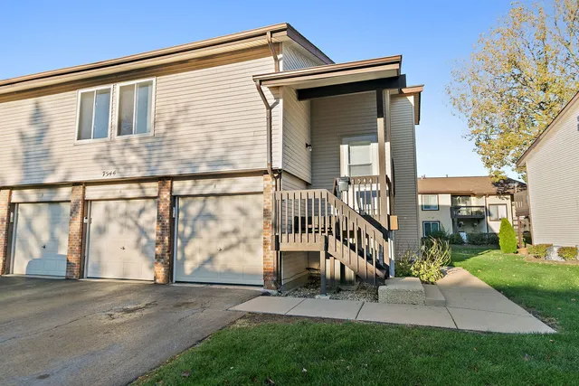 a view of backyard with a garden and deck