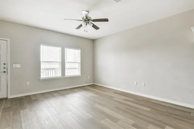 wooden floor in an empty room with a window