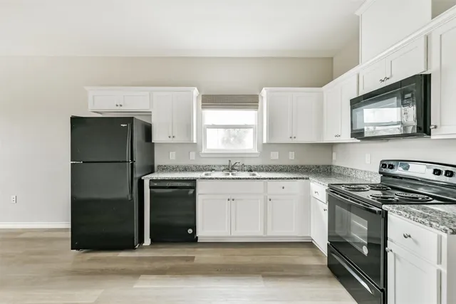 a kitchen with a stove microwave and refrigerator