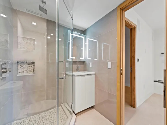 a bathroom with a shower and a sink