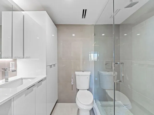 a bathroom with a toilet sink and shower