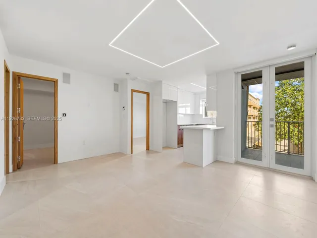 an empty room with windows and entrance