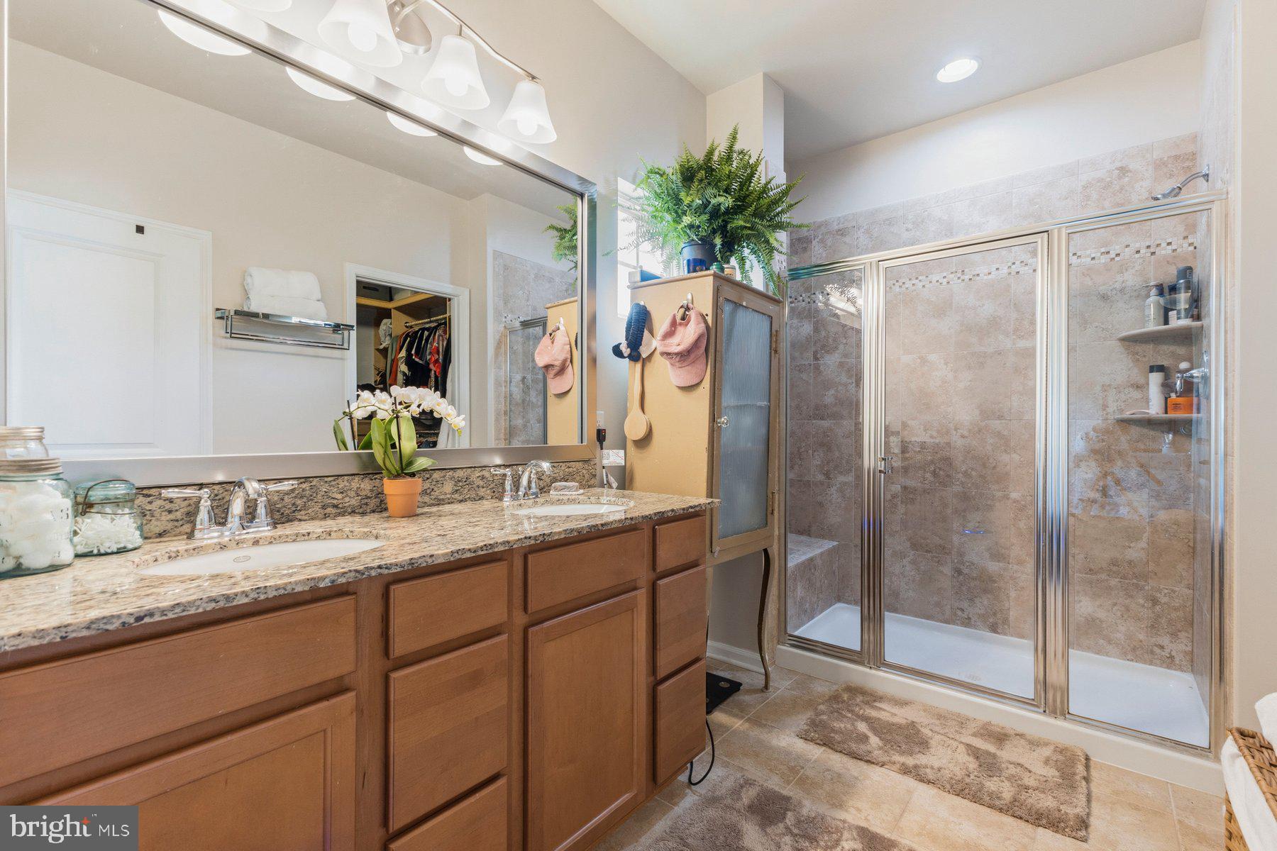 13708 Port Commerce Court Accokeek, MD 20607 - Photo 23 of 45 a bathroom with a granite countertop sink mirror and shower