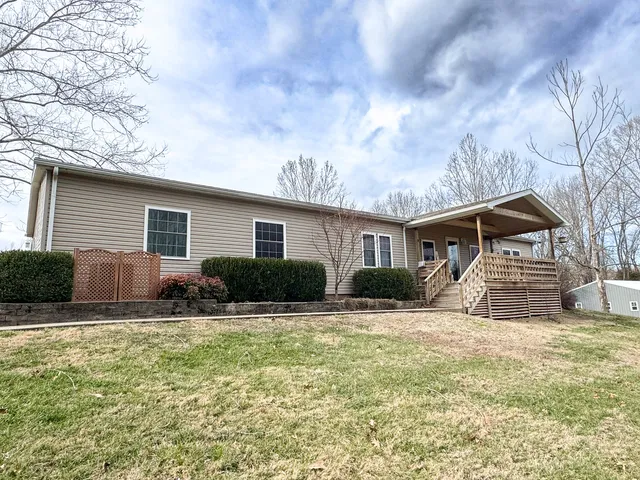 a front view of house with yard outdoor seating and barbeque oven