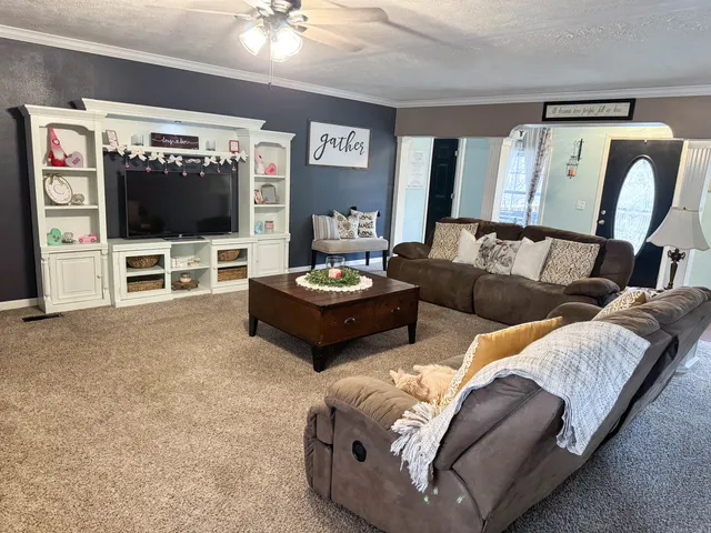 a living room with furniture and a flat screen tv
