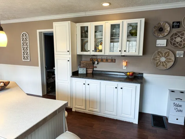 a kitchen with stainless steel appliances granite countertop a refrigerator and a stove