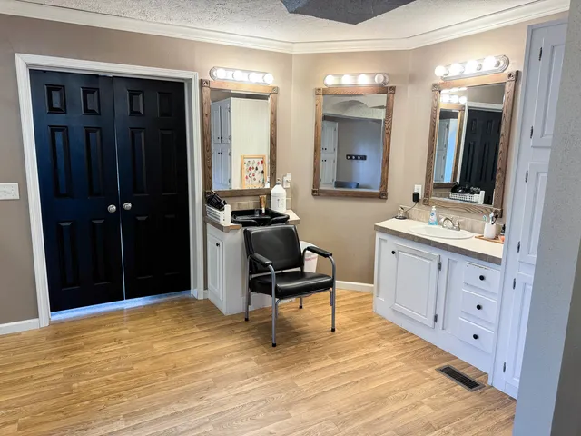 a bedroom with a bed and a mirror on the dresser