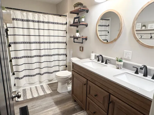 a bathroom with a toilet a sink and a mirror
