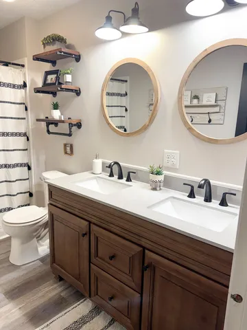 a bathroom with a toilet a sink and a mirror