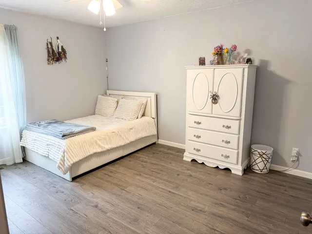 a bedroom with a bed and dresser