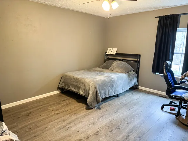 a bed sitting in a room next to a window