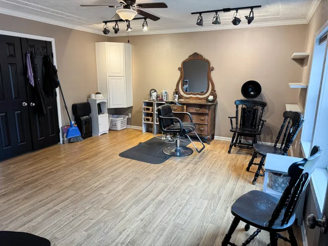 a view of a workspace with furniture and a window