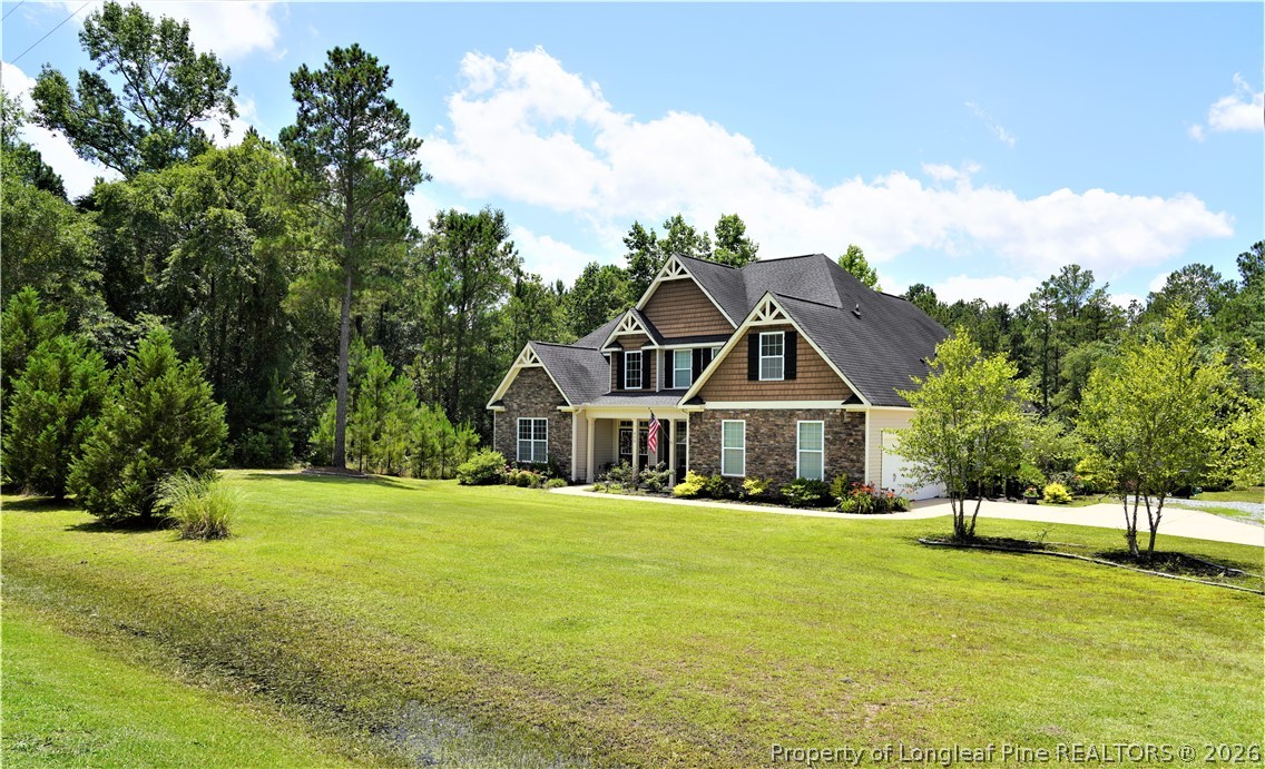930 Old Vander Road Fayetteville, NC 28312 - Photo 5 of 45 a front view of a house with a big yard and palm trees