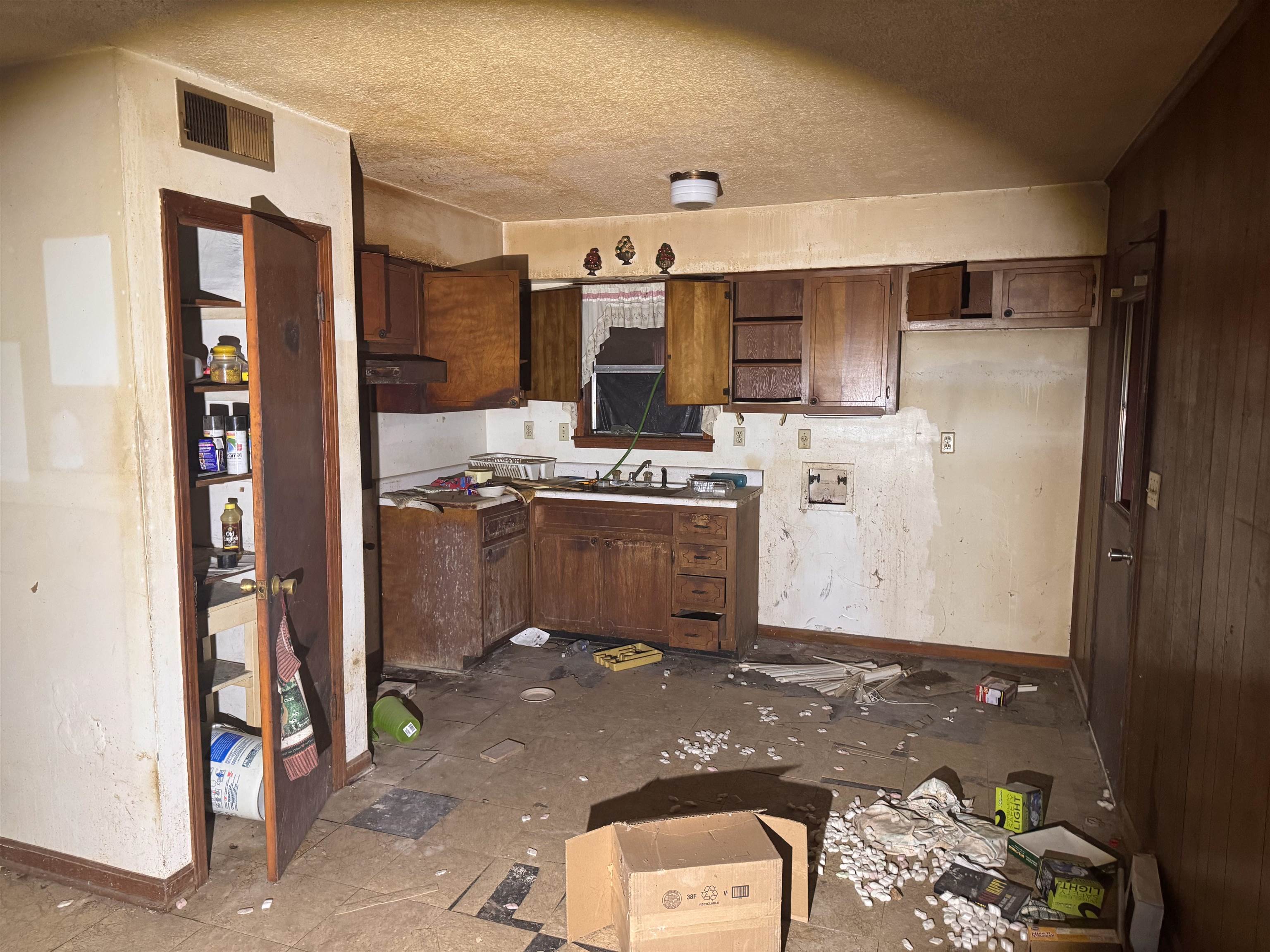 3251 Sinclair Street Memphis, TN 38127 - Photo 4 of 9 Kitchen with a textured ceiling and dark brown cabinets
