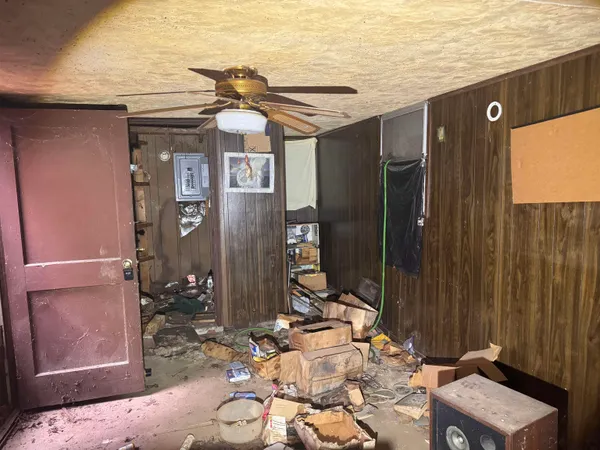 an empty room with a ceiling fan