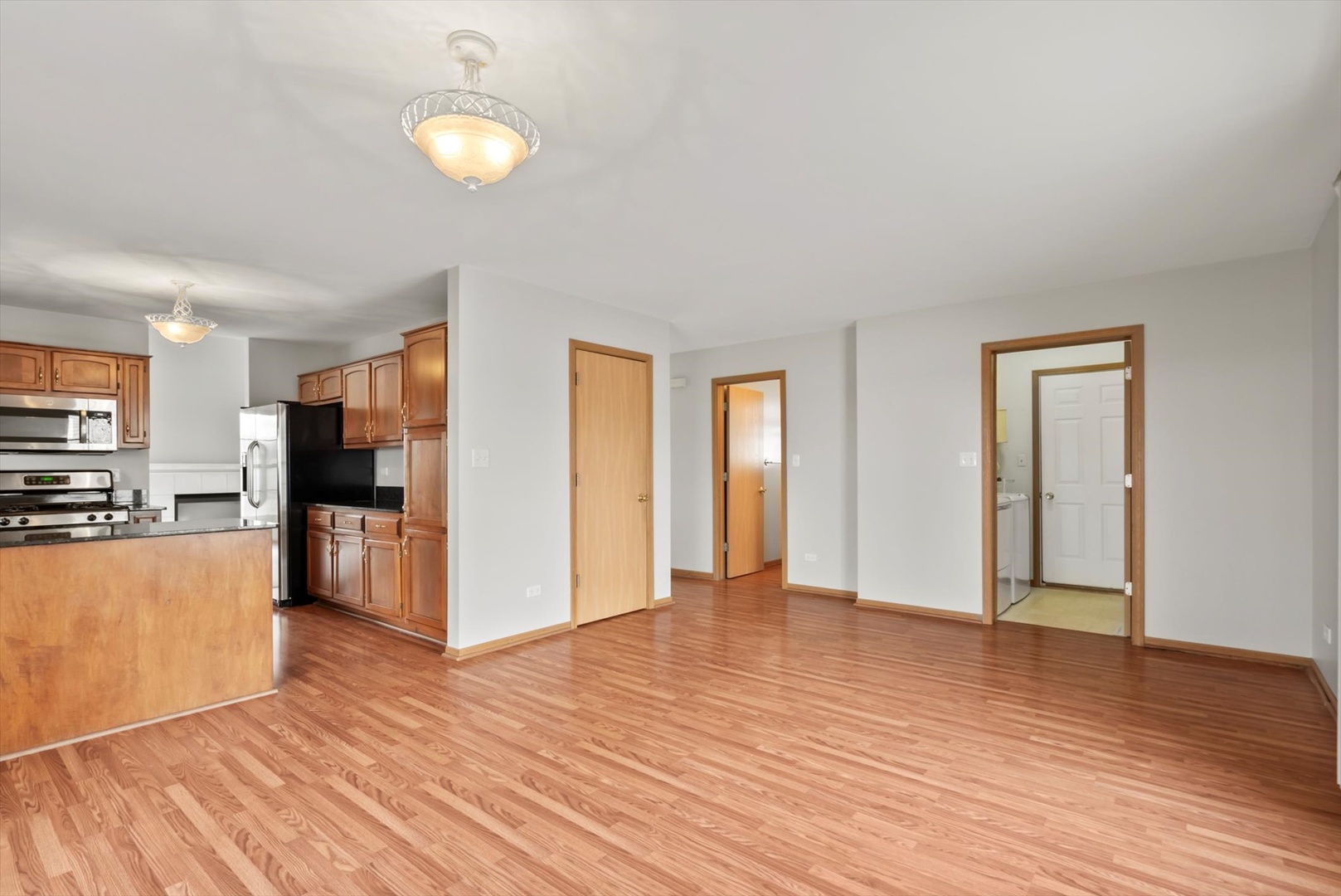 913 Barton Lane Peotone, IL 60468 - Photo 4 of 15 a view of a kitchen with wooden floor and a refrigerator