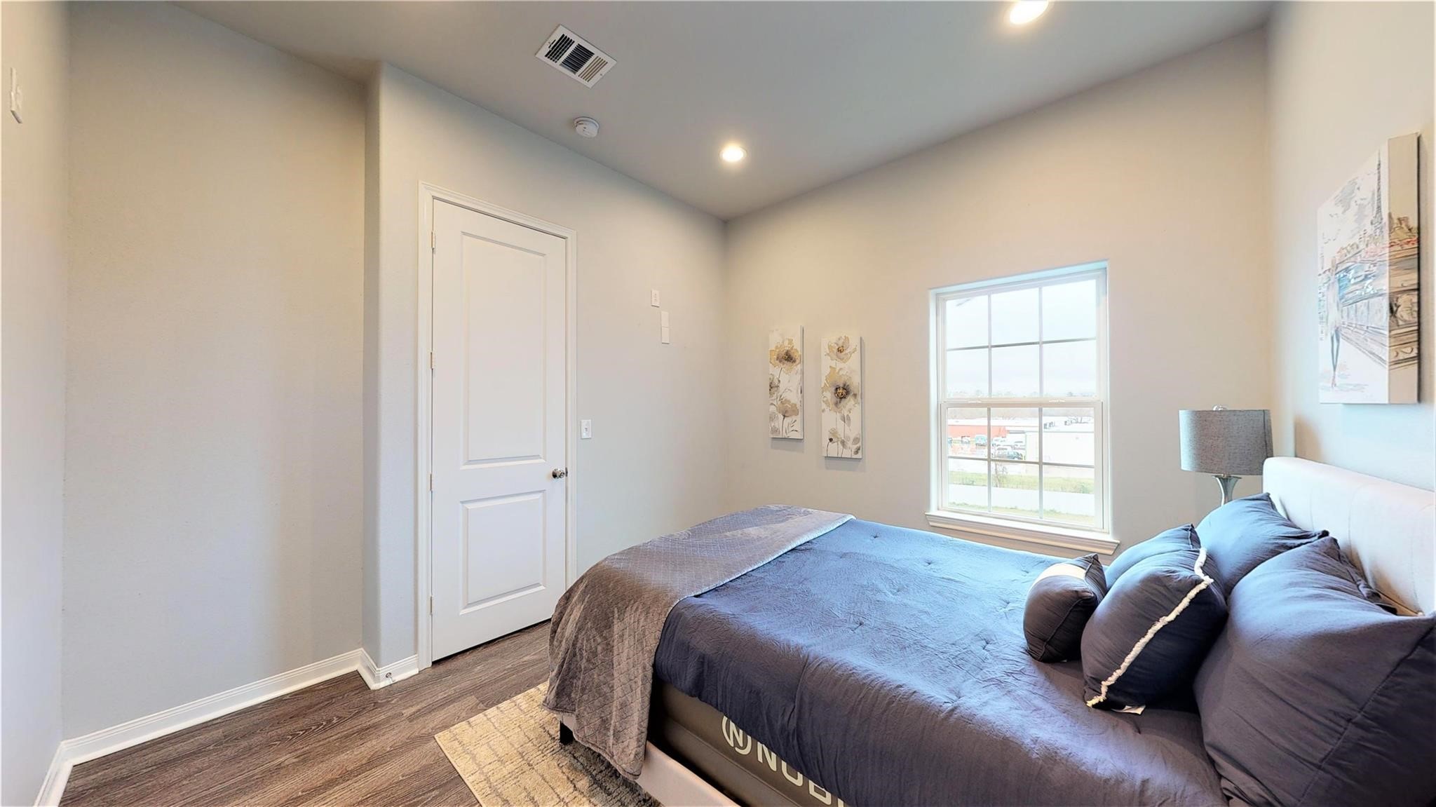 4924 Paradigm Ln Spring Spring, TX 77379 - Photo 15 of 18 This is a cozy, well-lit bedroom with neutral-color walls and wood flooring.