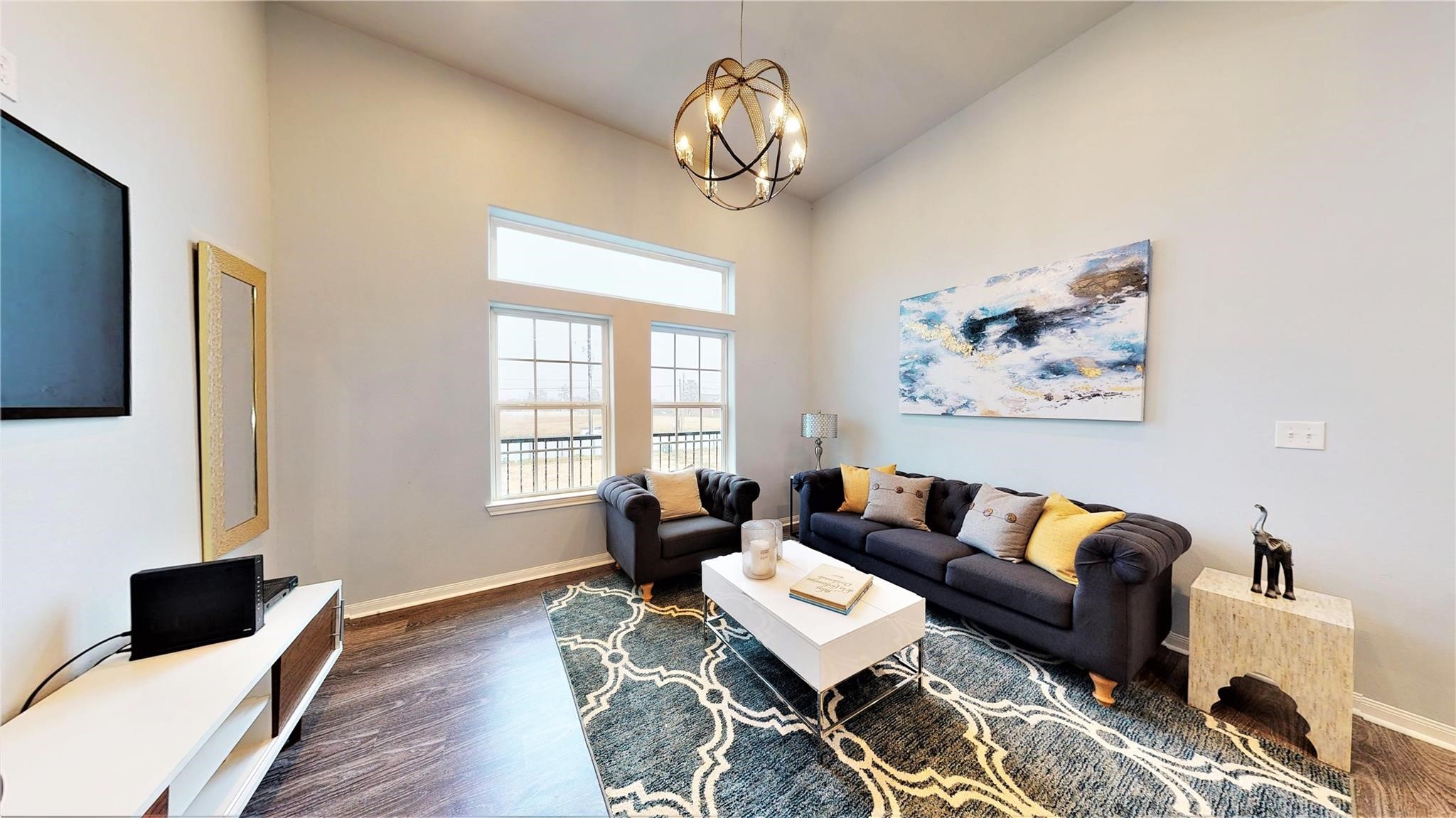 4924 Paradigm Ln Spring Spring, TX 77379 - Photo 3 of 18 This bright, modern living room features high ceilings, large windows, and stylish lighting. Create your cozy seating area and a welcoming and sophisticated atmosphere.