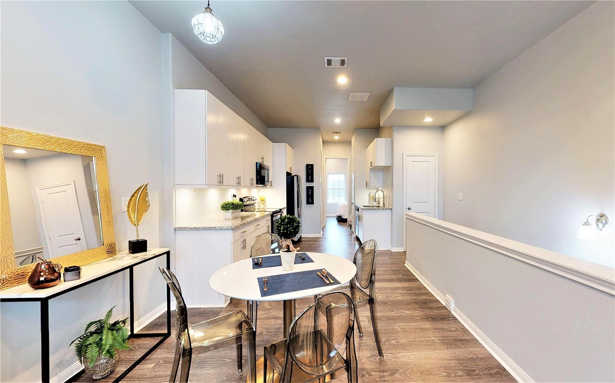 4924 Paradigm Ln Spring Spring, TX 77379 - Photo 5 of 18 The space is well-lit with recessed lighting and natural light from a distant window. The light wood flooring adds warmth to the clean.