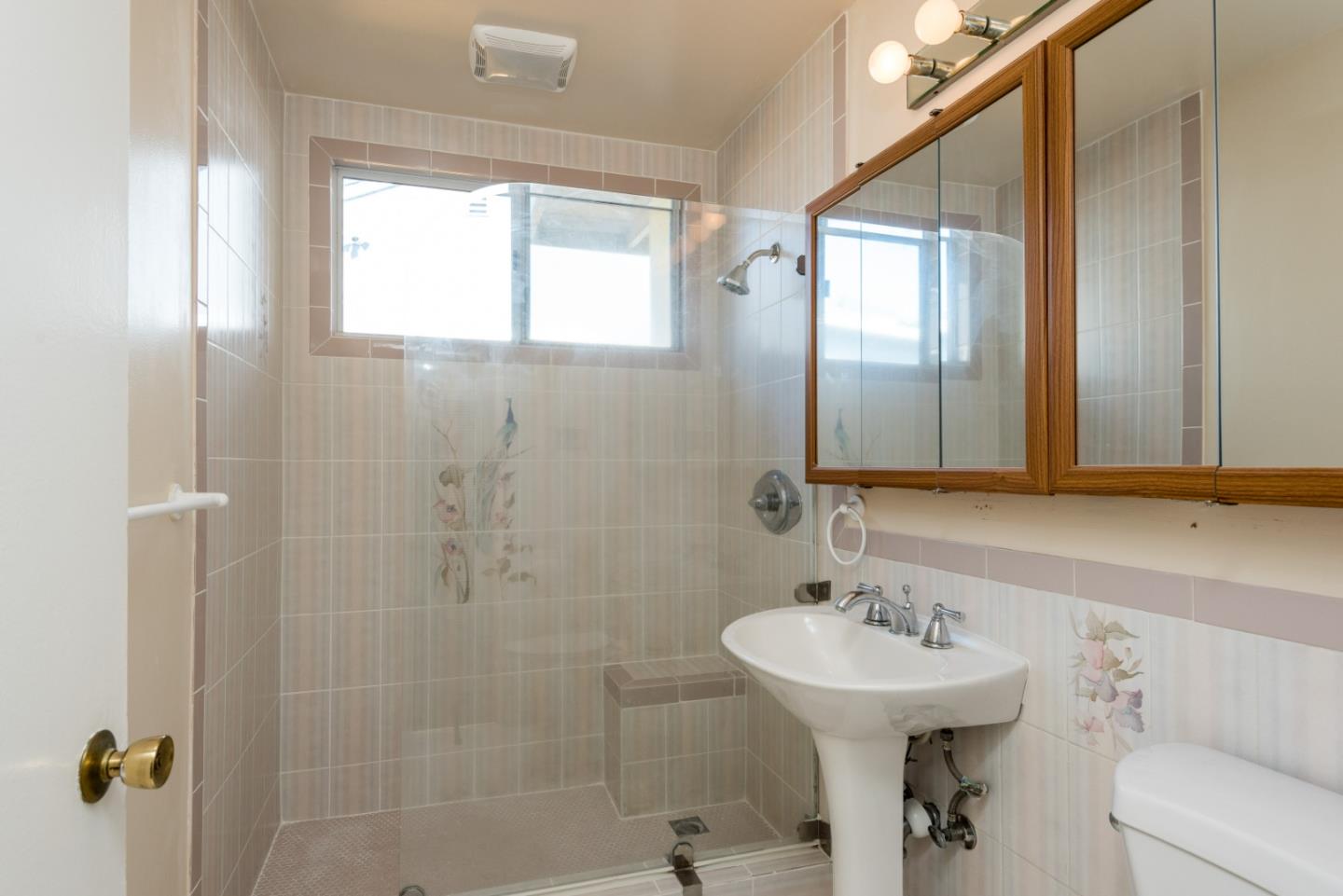 758 Pepper Drive San Bruno, CA 94066 - Photo 11 of 17 a bathroom with a sink a mirror and a shower