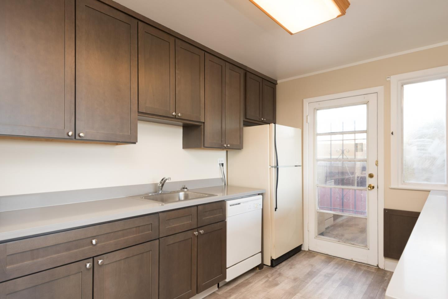758 Pepper Drive San Bruno, CA 94066 - Photo 7 of 17 a kitchen with a sink a refrigerator and cabinets
