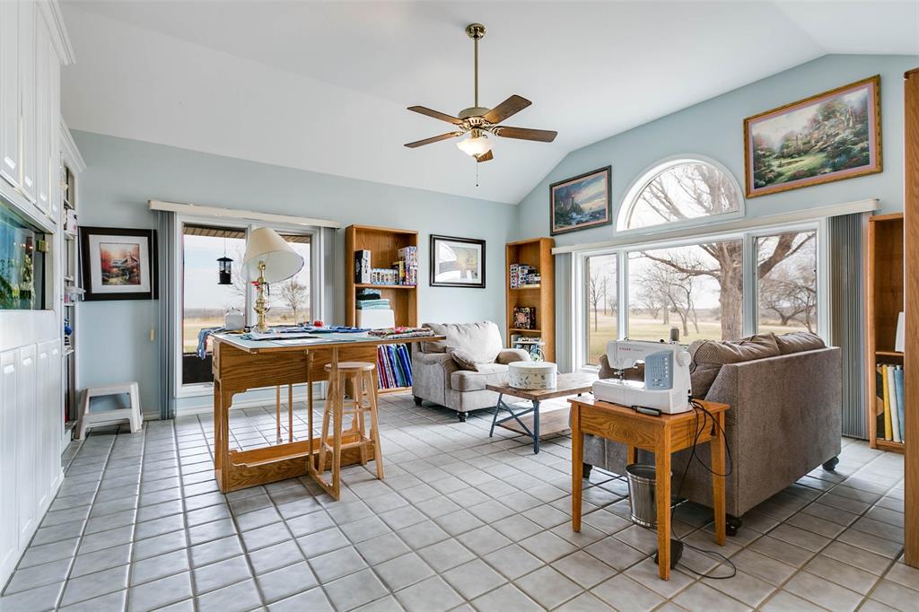 12487 County Road 4102 Hermleigh, TX 79526 - Photo 16 of 40 a living room with furniture a large window and a chandelier