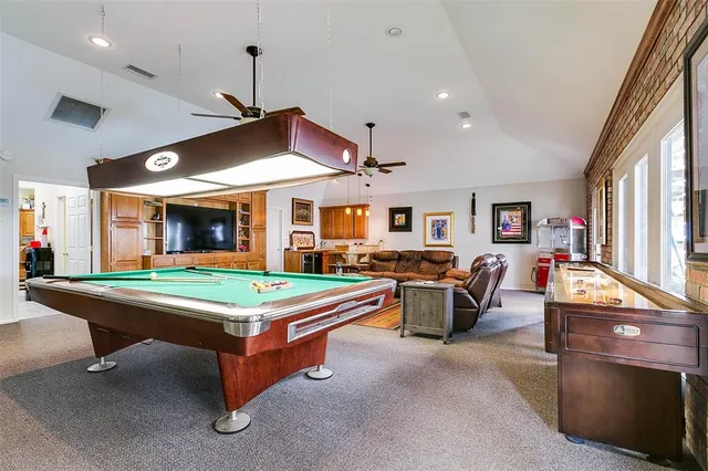 a dining room with stainless steel appliances kitchen island granite countertop furniture and a kitchen view