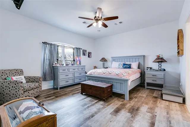 a bathroom with a granite countertop toilet sink and mirror