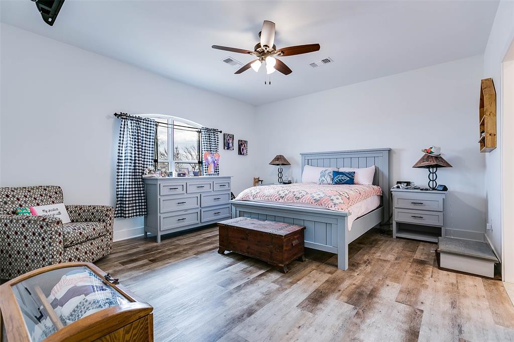 12487 County Road 4102 Hermleigh, TX 79526 - Photo 10 of 40 a bedroom with a bed and a couch