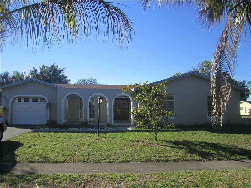 6320 Southwest 6th Street Margate, FL 33068 - Photo 1 of 8 a front view of a house with garden