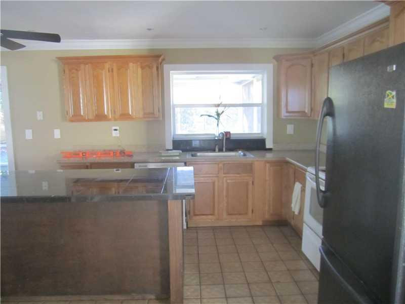 6320 Southwest 6th Street Margate, FL 33068 - Photo 3 of 8 a kitchen with a sink a refrigerator and window