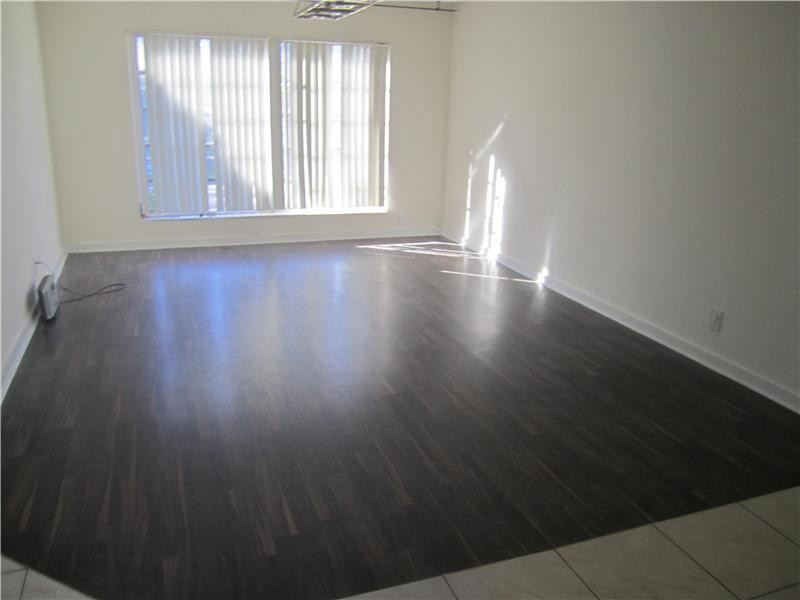 6320 Southwest 6th Street Margate, FL 33068 - Photo 5 of 8 an empty room with wooden floor and windows