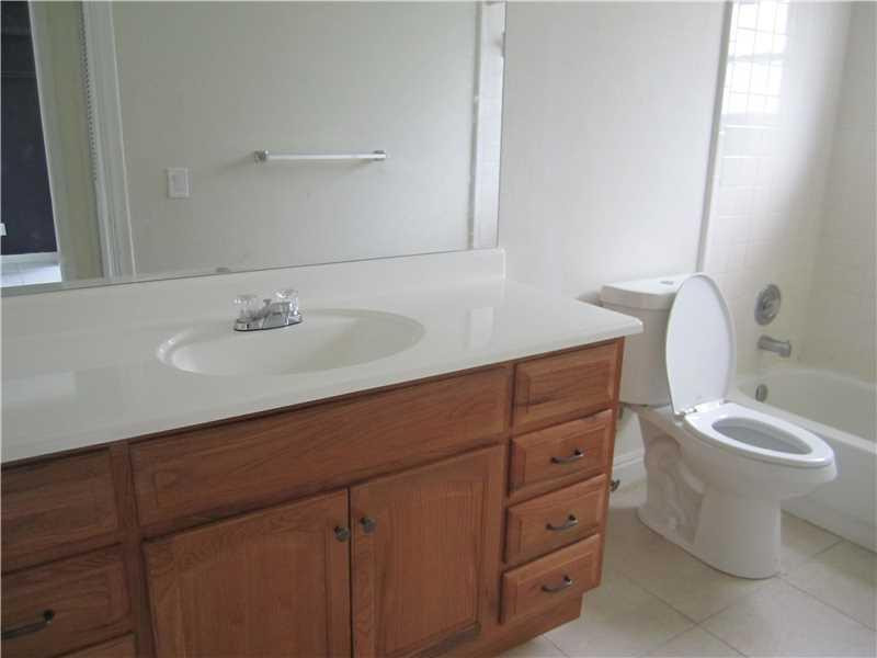 6320 Southwest 6th Street Margate, FL 33068 - Photo 6 of 8 a bathroom with a toilet sink and mirror