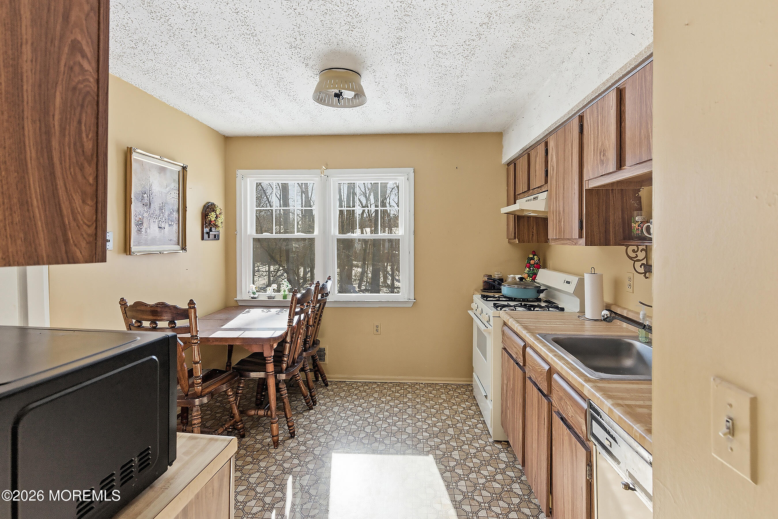 15 Standish Drive Howell, NJ 07731 - Photo 7 of 14 a kitchen with granite countertop a sink stove and cabinets
