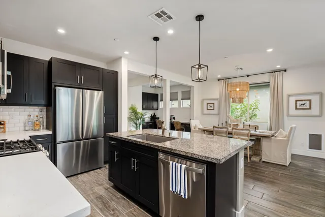 a living room with furniture a large window and a flat screen tv
