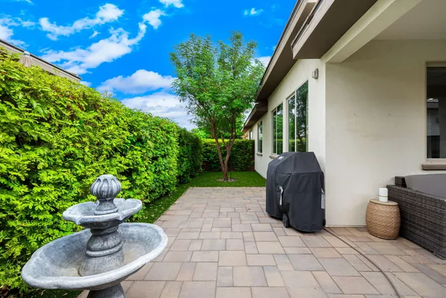 a view of a house with backyard and sitting area