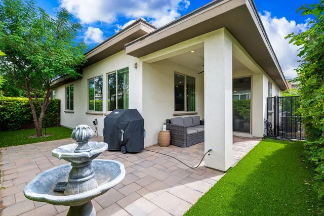 a view of backyard with outdoor seating and green space