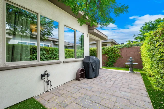 a front view of a house with a yard table and chairs