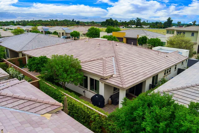 an aerial view of a house with swimming pool garden and lake view