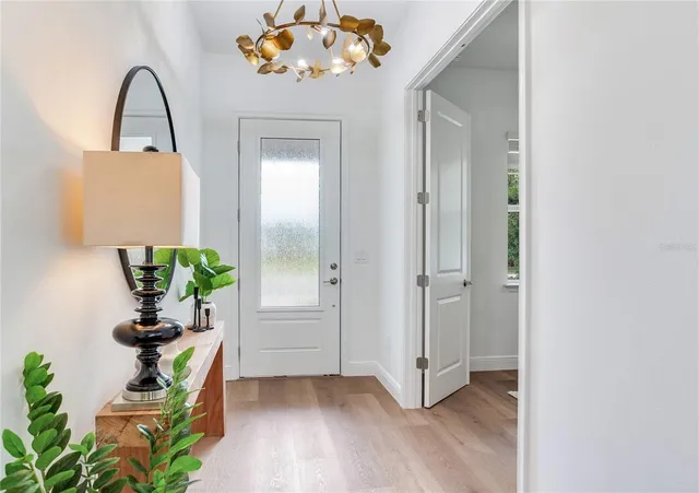 a kitchen with stainless steel appliances kitchen island granite countertop a table chairs and a refrigerator