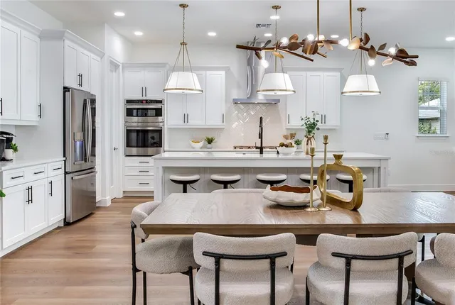 a kitchen with stainless steel appliances granite countertop a stove a sink and a refrigerator