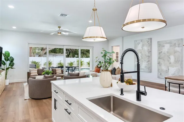 a living room with furniture and kitchen view