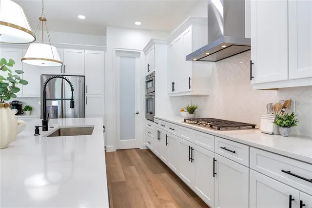 a living room with furniture kitchen view and a flat screen tv
