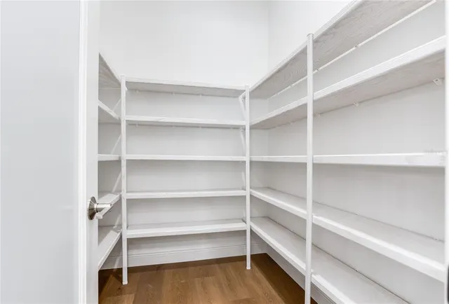 a bedroom with a bed rug and window