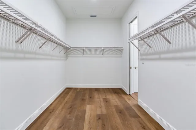 a view of a patio with table and chairs potted plants and a large tree
