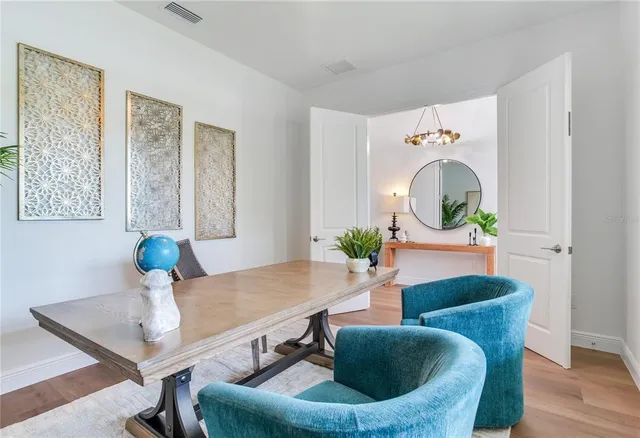 a view of a dining room with furniture window and wooden floor