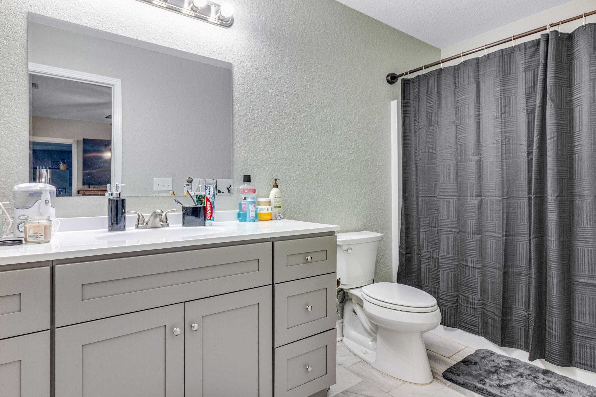 107 Eastview Drive Crestview, FL 32536 - Photo 15 of 23 a bathroom with a sink a toilet and shower curtain