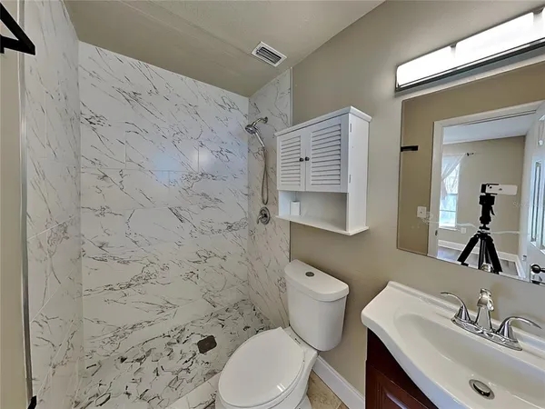 a bathroom with a sink toilet and shower